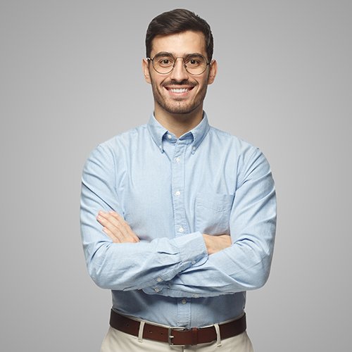 successful-young-businessman-standing-with-crossed-RGT9RF4